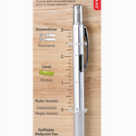 Multifunctional pen tool with ruler on a wooden backing. Available at Be Charmed. 