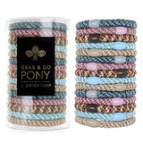 Stack of colorful hair ties with a container labeled 'Grab & Go Pony' on a white background. Available at Be Charmed