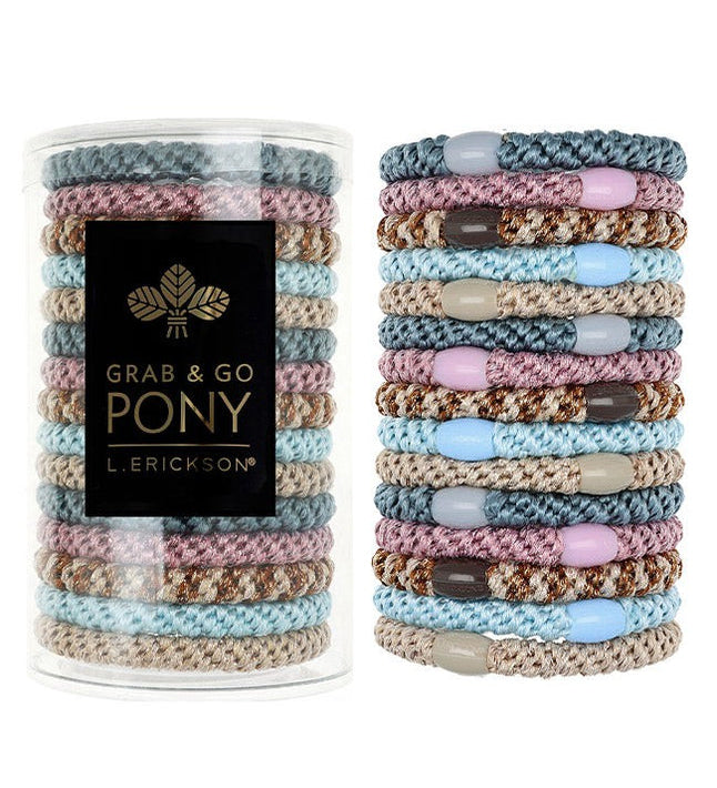 Stack of colorful hair ties with a container labeled 'Grab & Go Pony' on a white background. Available at Be Charmed