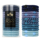 Blue hair ties in a cylindrical container with L Erickson branding on a white background. Available at Be Charmed