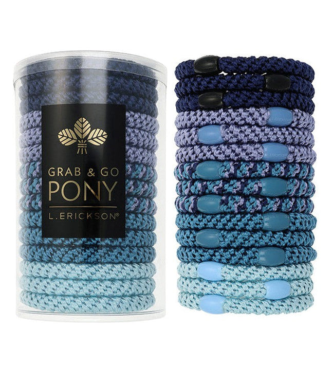 Blue hair ties in a cylindrical container with L Erickson branding on a white background. Available at Be Charmed