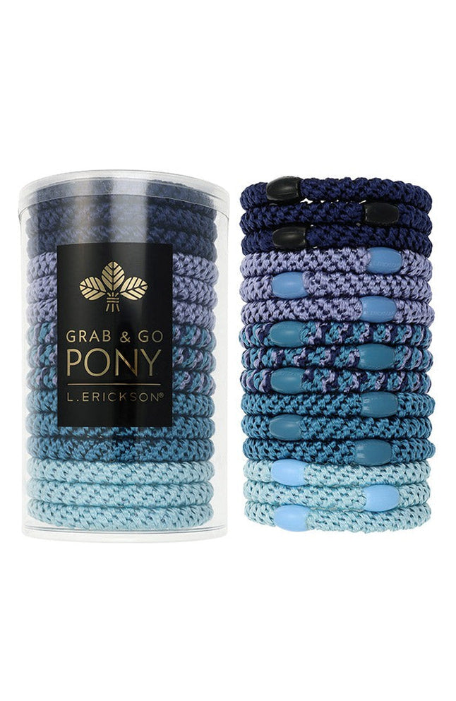 Blue hair ties in a cylindrical container with L Erickson branding on a white background. Available at Be Charmed