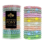 Pastel colored hair ties in two stacks with a black box labeled 'Grab & Go Pony' on a white background. Available at Be Charmed
