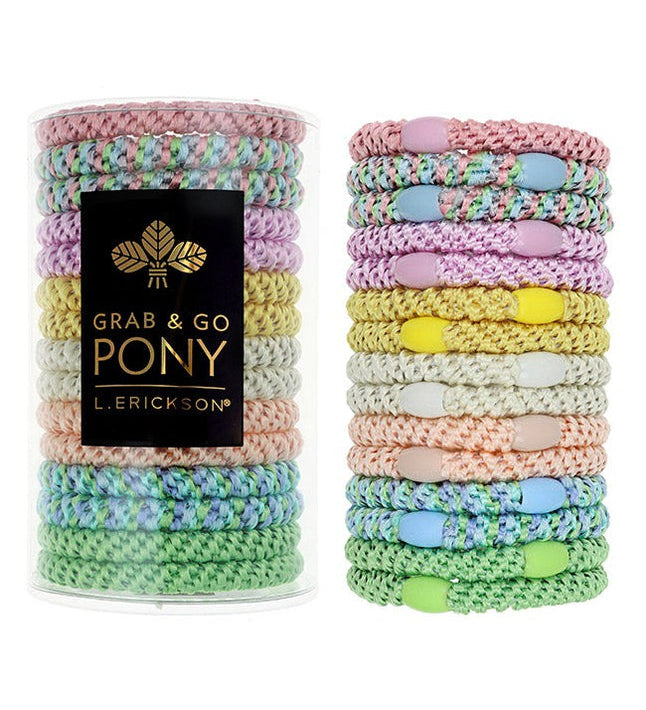 Pastel colored hair ties in two stacks with a black box labeled 'Grab & Go Pony' on a white background. Available at Be Charmed