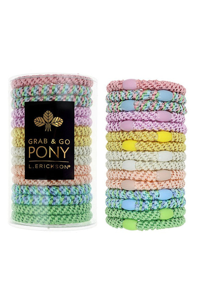 Pastel colored hair ties in two stacks with a black box labeled 'Grab & Go Pony' on a white background. Available at Be Charmed