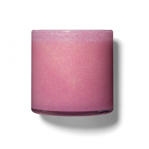 A rectangular pink candle with a textured wick, set against a clear background. Available at Be Charmed