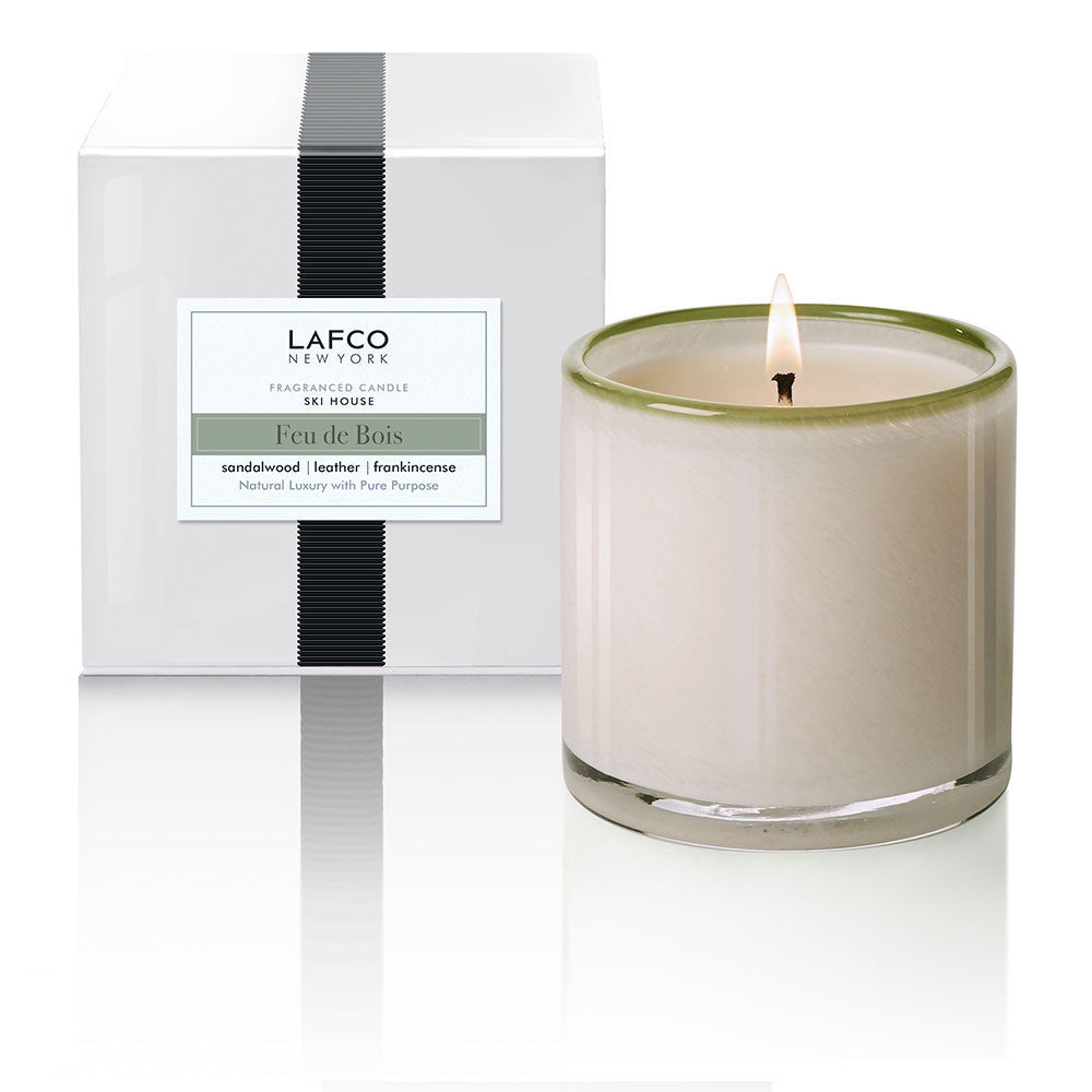 LAFCO 15.5 oz Ski House Candle in Feu De Bois with smoky woods, leather, and spice. Cozy fireside fragrance. Available at Be Charmed.