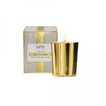 A gold-colored candle with a frosted pine spice scent, presented in a LAFCO branded box. Available at Be Charmed