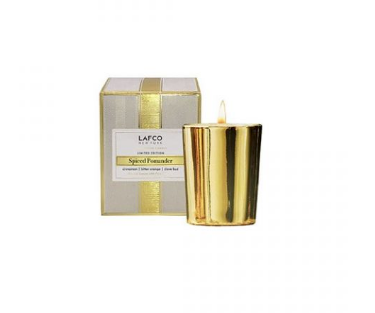 A gold-colored candle with a frosted pine spice scent, presented in a LAFCO branded box. Available at Be Charmed
