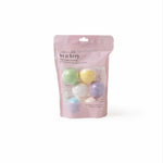 Pink packaging of mini bath bombs with colorful spheres on a white background. Available at Be Charmed