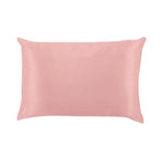 Pink satin pillowcase on a white background. Available at Be Charmed