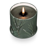 Candle in a green container with leaf design on a white background. Available at Be Charmed