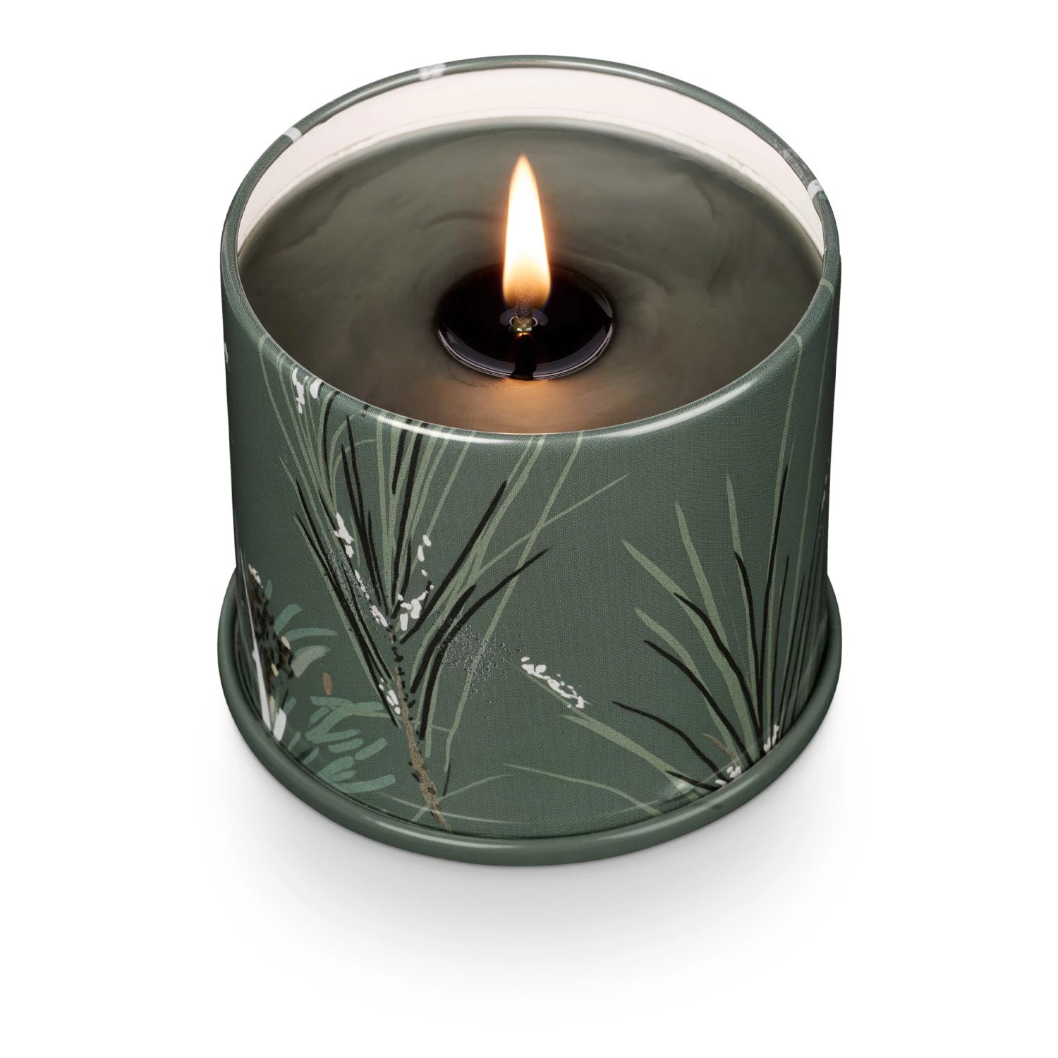 Candle in a green container with leaf design on a white background. Available at Be Charmed