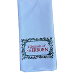 Sherborn Little Birdie Holly Border Town Tea Towel – festive holiday kitchen towel with charming town design, handcrafted and available at Be Charmed.