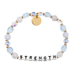 Bracelet with beads and letter tiles spelling 'STRENGTH' on a white background. Available at Be Charmed