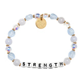 Bracelet with beads and letter tiles spelling 'STRENGTH' on a white background. Available at Be Charmed