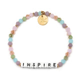 Little Words Project Dream in Color Inspire Bracelet – Colorful beaded bracelet with white letter beads spelling "INSPIRE," available at Be Charmed.