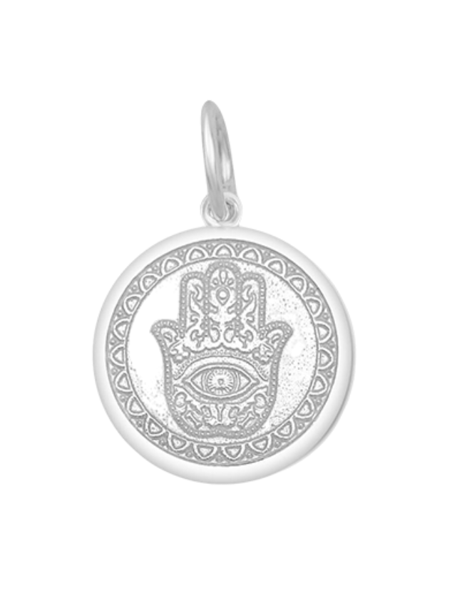 A Lola sterling silver pendant with an alpine white center featuring the Hamsa Hand, with enamel inlay. Available at Be Charmed