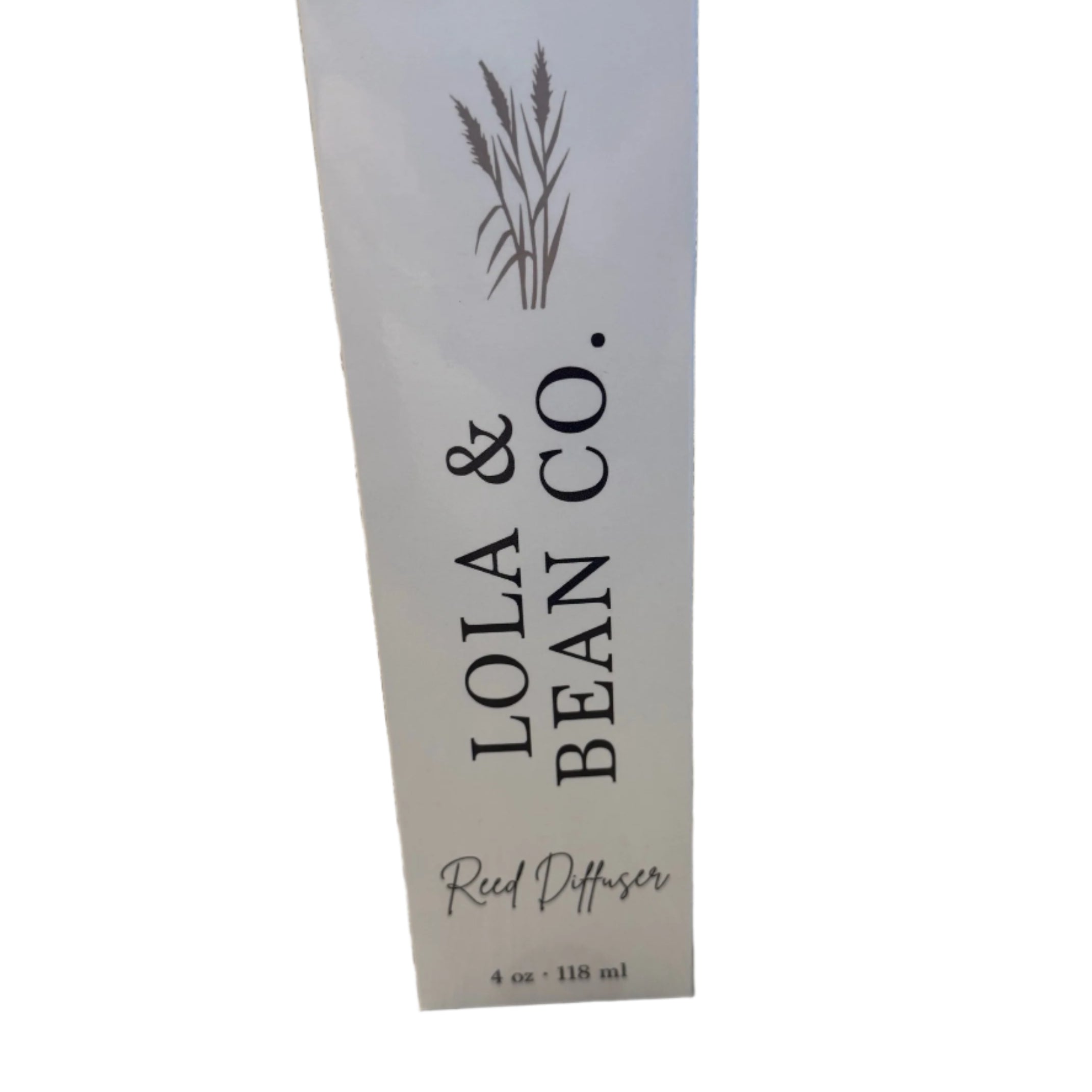 Box picture of Lola & Bean 4oz Reed Diffuser – Clear glass bottle with gold collar, featuring rattan reeds and a subtle label, available at Be Charmed.