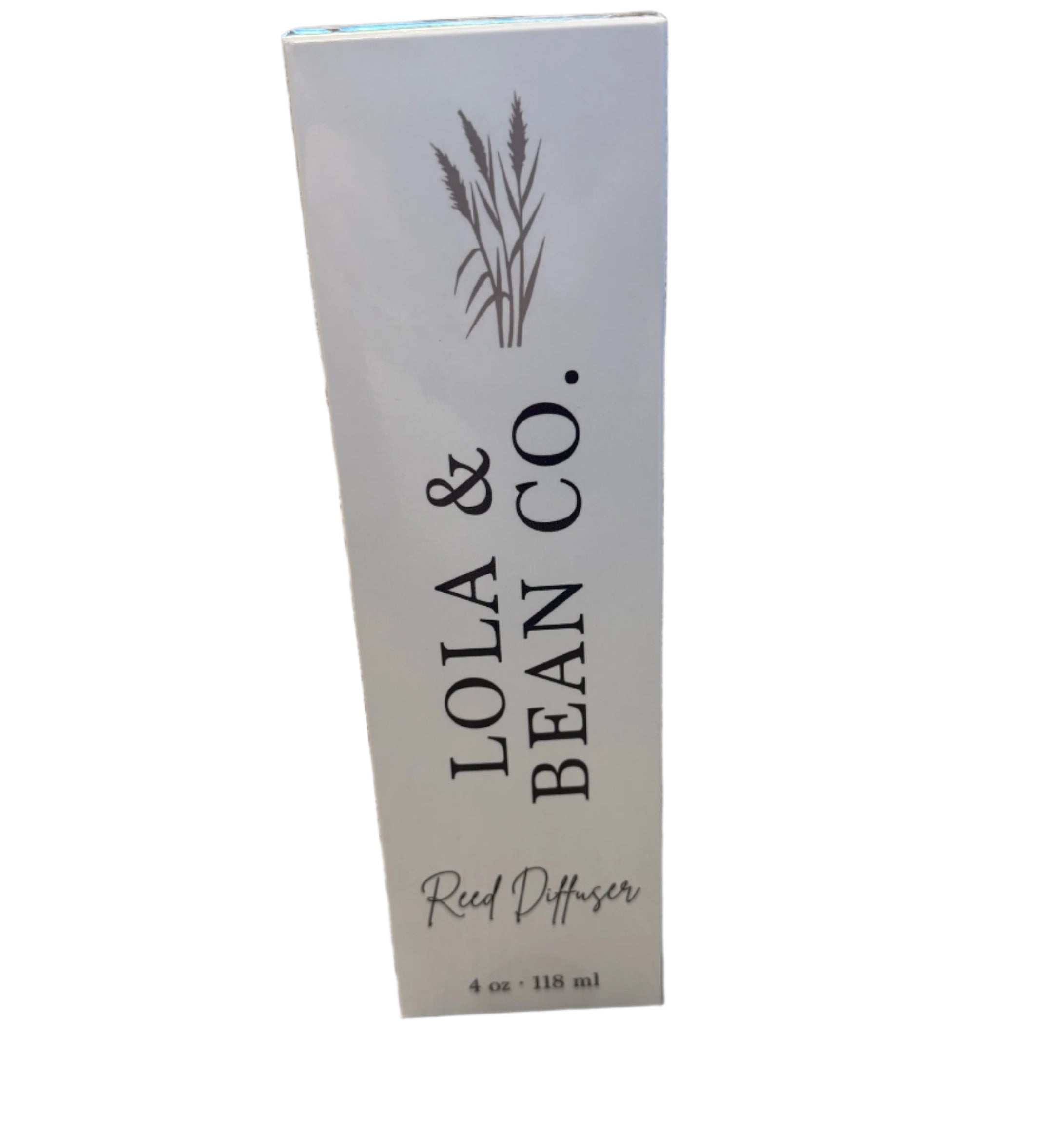 Box picture of Lola & Bean 4oz Reed Diffuser – Clear glass bottle with gold collar, featuring rattan reeds and a subtle label, available at Be Charmed.