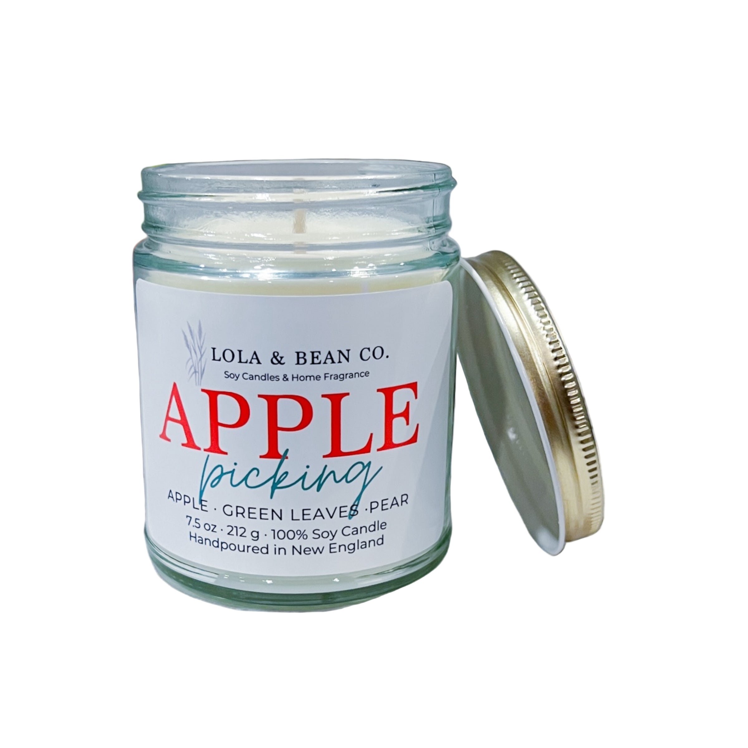 Candle jar labeled 'Apple Picking' by Lola & Bean Co. on a white background. Available at Be Charmed. 