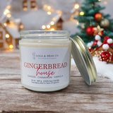 Lola & Bean 7.5 oz Soy Candle in Gingerbread House — warm cinnamon, clove, and vanilla scent in a clean-burning jar. Available at Be Charmed