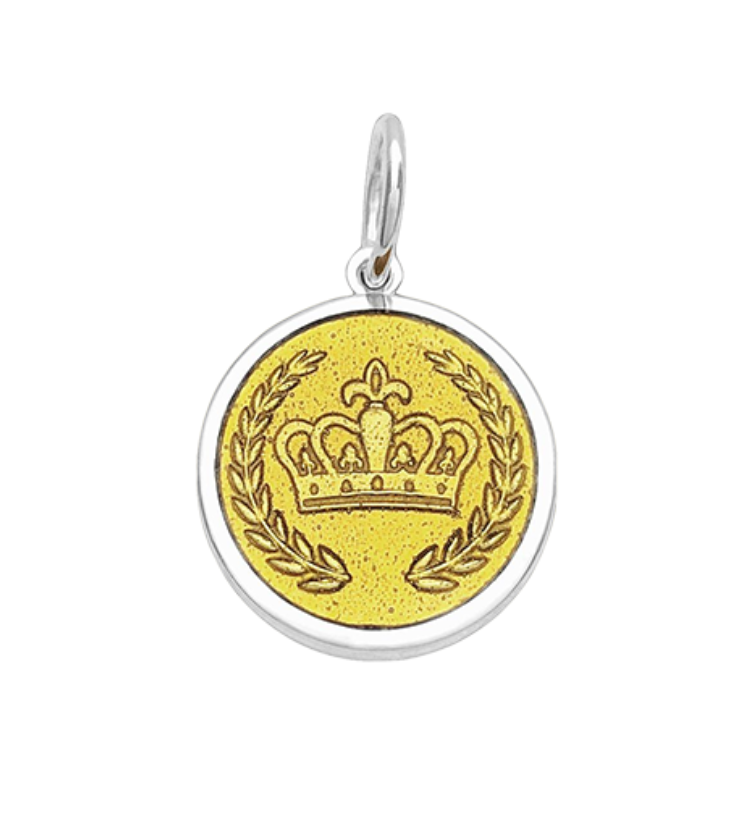 A Lola sterling silver pendant with a gold vermeil center featuring a crown design and the engraved text 'GRIT & GRACE' on the back. Available at Be Charmed
