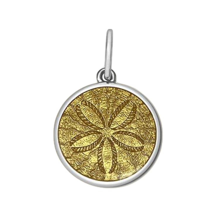 A sterling silver pendant with a gold vermeil center, featuring an engraved design resembling a sand dollar. Available at Be Charmed