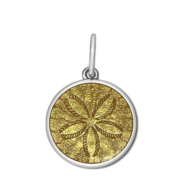 A sterling silver pendant with a gold vermeil center, featuring an engraved design resembling a sand dollar. Available at Be Charmed
