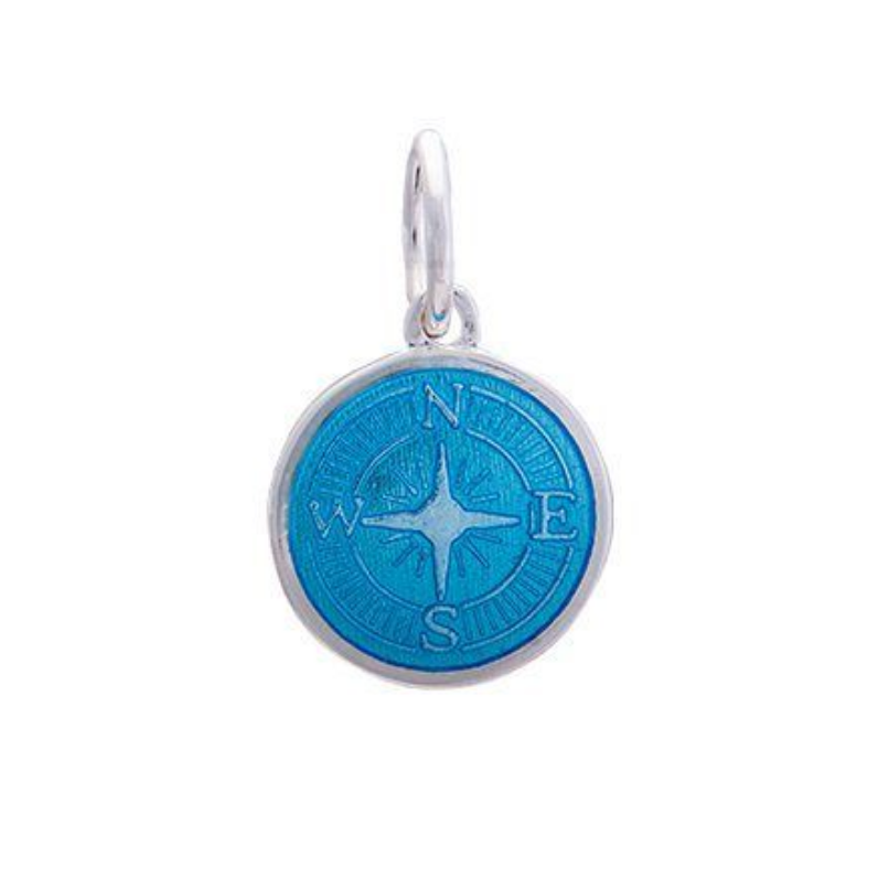 A sterling silver pendant with a blue enamel inlay designed to resemble a compass. Available at Be Charmed