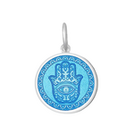 A Lola sterling silver pendant with an light blue center featuring the Hamsa Hand, with enamel inlay. Available at Be Charmed