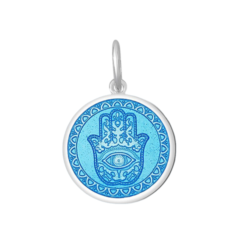 A Lola sterling silver pendant with an light blue center featuring the Hamsa Hand, with enamel inlay. Available at Be Charmed