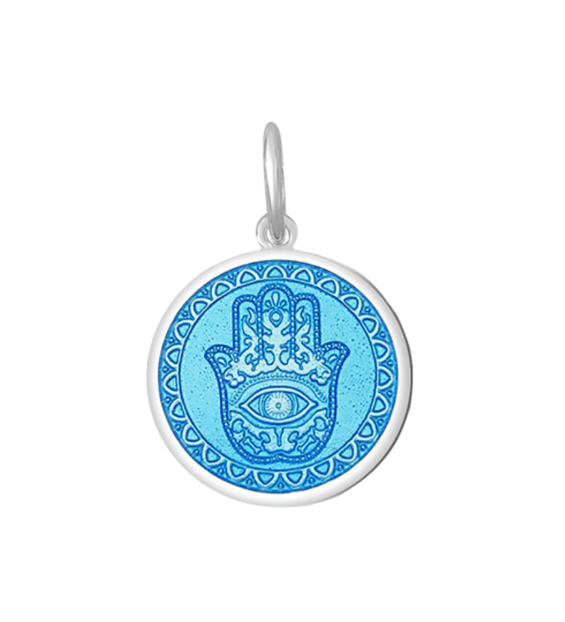 A Lola sterling silver pendant with an light blue center featuring the Hamsa Hand, with enamel inlay. Available at Be Charmed
