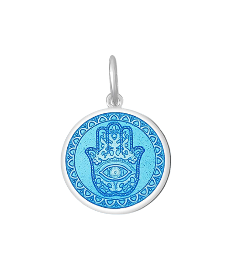 A Lola sterling silver pendant with an light blue center featuring the Hamsa Hand, with enamel inlay. Available at Be Charmed