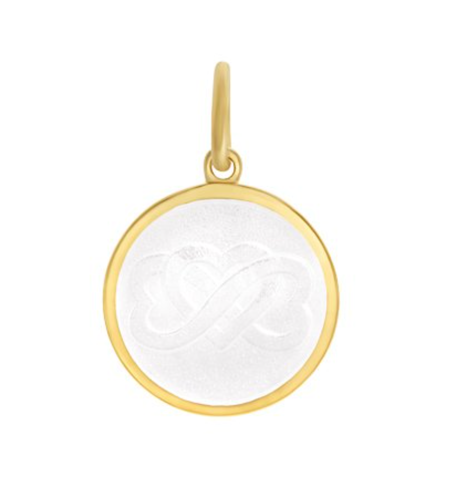 A mother son gold pendant with a white enamel inlay in the shape of a heart, with a loop for a chain attachment at the top. Available at Be Charmed