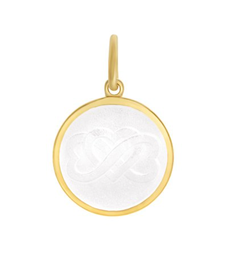 A mother son gold pendant with a white enamel inlay in the shape of a heart, with a loop for a chain attachment at the top. Available at Be Charmed