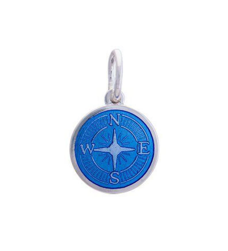 A sterling silver pendant with a blue enamel inlay designed to resemble a compass. Availble at Be Charmed