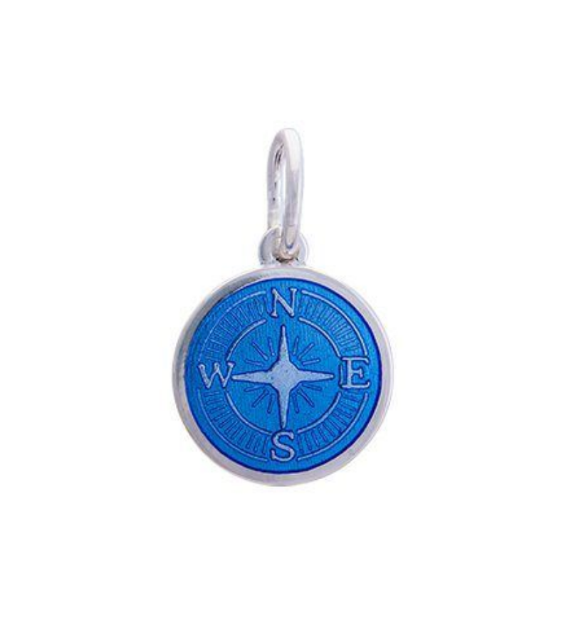 A sterling silver pendant with a blue enamel inlay designed to resemble a compass. Availble at Be Charmed
