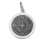 A sterling silver pendant with a Pewter enamel inlay designed to resemble a compass. Available at Be Charmed