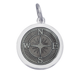 A sterling silver pendant with a Pewter enamel inlay designed to resemble a compass. Available at Be Charmed