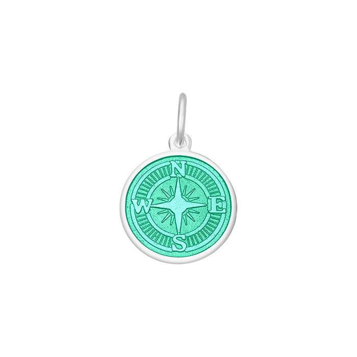 A sterling silver pendant with a blue enamel inlay designed to resemble a compass. Available at Be Charmed