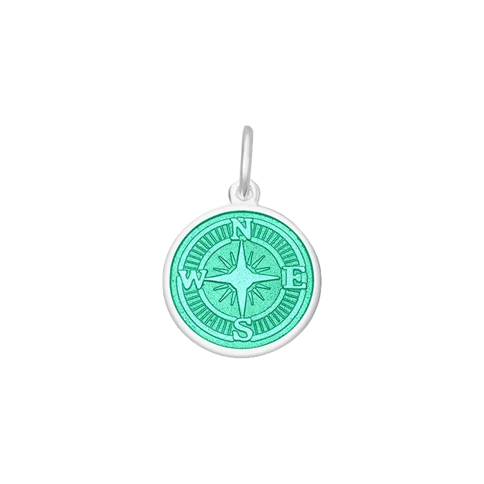 A sterling silver pendant with a blue enamel inlay designed to resemble a compass. Available at Be Charmed