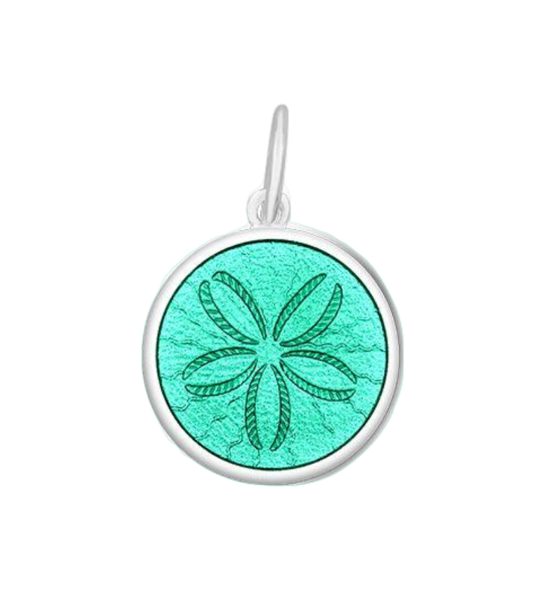 A sterling silver pendant with a seafoam enamel inlay, featuring an engraved design resembling a sand dollar. Available at Be Charmed