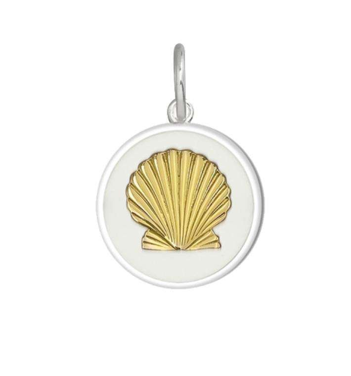 Lola alpine white A gold-plated, round pendant featuring a shell design on a white background. Available at Be Charmed