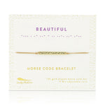 Lucky Feather Beautiful Morse Code Bracelet on card featuring a gold-dipped bar engraved with the word 'Beautiful' in Morse code, on an adjustable cord. Available at Be Charmed.