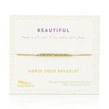 Lucky Feather Beautiful Morse Code Bracelet on card featuring a gold-dipped bar engraved with the word 'Beautiful' in Morse code, on an adjustable cord. Available at Be Charmed.