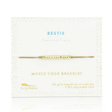 Lucky Feather Bestie Morse Code Bracelet on card featuring a gold-dipped bar engraved with 'Bestie' in Morse code, on an adjustable cord. Available at Be Charmed.