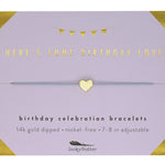 Gold bracelet on a purple card with text about birthday celebration bracelets. Available at Be Charmed