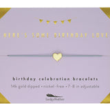 Gold bracelet on a purple card with text about birthday celebration bracelets. Available at Be Charmed