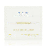 Lucky Feather Fearless Morse Code Bracelet on card featuring a gold-dipped bar engraved with 'Fearless' in Morse code, on an adjustable cord. Available at Be Charmed.